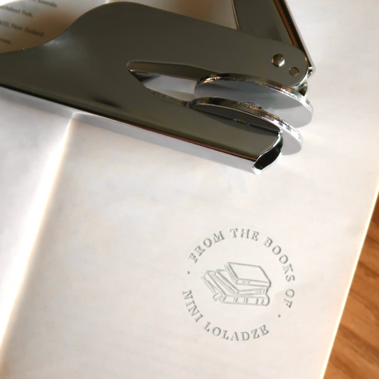 Personalized Book Embosser with a Stack of Books Illustration – Round Paper Seal